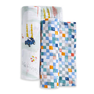 The aden + anais essentials cotton muslin swaddle blanket 2 pack includes one blue and orange checkered design and one featuring whimsical cars, trees, and red accents on a white background.