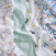 Three soft essentials cotton muslin swaddle blankets from aden + anais are shown: one with colorful pennants, one with cars and trees, and one in blue-orange checks, all displayed on a white background.