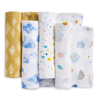 The aden + anais essentials cotton muslin swaddle blanket 4 pack features soft, breathable blankets in yellow geometric, blue clouds, colorful diamonds, and rainbows with clouds patterns—perfect for cozy baby moments.