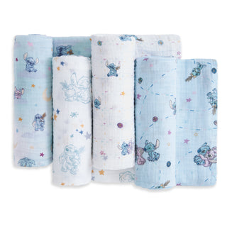 The aden + anais essentials cotton muslin swaddle blanket 4 pack includes pastel blue and white blankets with playful cartoon alien, star, and planet designs, made from soft, breathable cotton muslin.
