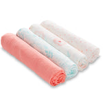 Four rolled aden + anais essentials cotton muslin swaddle blankets are side by side. The designs feature solid pink, floral, leafy patterns, and pink polka dots on white backgrounds, making them perfect for your babys peaceful rest.