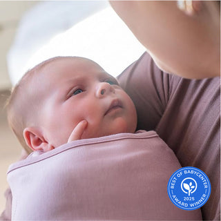 A baby wrapped in a HALO SuperSoft Bamboo Swaddle TOG 2.0 looks up at an adult holding them. A blue Best of BabyCenter 2025 Award Winner badge is visible in the lower right corner.