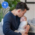 A man in a blue shirt lovingly kisses a swaddled baby in a HALO SuperSoft Bamboo Swaddle TOG 2.0 while holding the baby. A Best of BabyCenter 2025 Award Winner badge is shown in the top left corner.