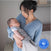 A woman in a blue sweater gently holds a baby wrapped in the HALO SuperSoft Bamboo Swaddle TOG 2.0. A Best of BabyCenter 2025 Award Winner badge is displayed in the lower right corner.