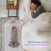 A swaddled infant sleeps on a Bedside Sleeper DreamWeave Breathable Pad in a bedside sleeper next to a parent in bed.