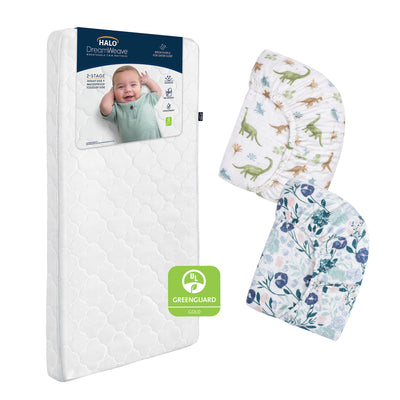 The HALO Breathable Crib Mattress Bundle is shown with a smiling baby on the label, beside two cotton muslin crib sheets—one dinosaur print and one with blue and green leaves. A GREENGUARD Gold certification badge appears in front.