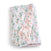 The aden + anais essentials cotton muslin dream blanket is a folded, quilted blanket featuring coral floral and green leaf prints on a white base. It promises cozy snuggles with its white-trimmed edges and soft blush pink underside.
