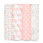 Displayed are four rolls from the aden + anais essentials cotton muslin swaddle blanket 4 pack: multicolored tulips, pink hearts, white stars on pink, and green leaves with orange dots. These soft, pastel-toned designs are crafted from breathable cotton muslin.