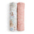 Two essentials silky soft swaddle blankets by aden + anais are rolled side by side: the left swaddle has a blue and beige floral pattern on white bamboo-infused fabric, while the right features a white floral design on pink, ideal for babys sensitive skin.