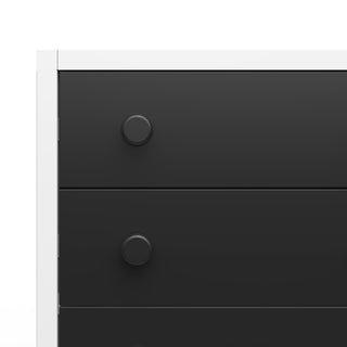Close-up of the left side of the Child Craft Orbit 4 Drawer Chest in Ebony/Matte White, showing two drawers with round black knobs and a minimalistic design featuring clean lines.