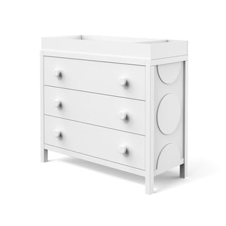 The Child Craft F01792 Universal Changing Table Topper in matte white features a raised top edge, round knobs, and circular side accents—perfect for pairing with a three-drawer dresser or baby diaper changing tray.