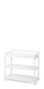The Child Craft Flat Top Baby Changing Table in matte white features baby-safe finishes, two open storage shelves, and raised sides for safety, all showcased against a plain white background.