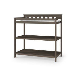 The Child Craft Flat Top Baby Changing Table in dapper gray features two open nursery storage shelves and a top baby changing pad, shown on a white background.