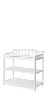 The Child Craft Arch Top Baby Changing Table in matte white features two open storage shelves and a decorative slatted back, ideal for nursery use. Shown against a plain white background.