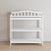 The Child Craft Arch Top Baby Changing Table in matte white features slatted sides, two open shelves, and a curved top backrest—perfect nursery furniture for organized storage and style.