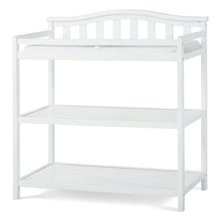 The Child Craft Arch Top Baby Changing Table in matte white features a curved back, padded changing pad, and two open storage shelves—ideal nursery furniture for keeping baby essentials organized.