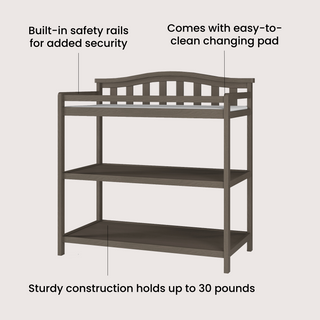 The Child Craft Arch Top Baby Changing Table in Dapper Gray features built-in safety rails, an easy-to-clean pad, two open shelves, and sturdy construction supporting up to 30 lbs—an ideal nursery essential.
