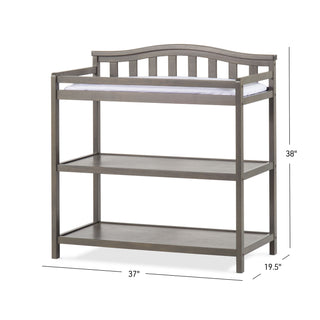 The Child Craft Arch Top Baby Changing Table in Dapper Gray features an arched back rail, two open shelves, and a top changing pad. This stylish nursery piece measures 37"W x 19.5"D x 38"H.