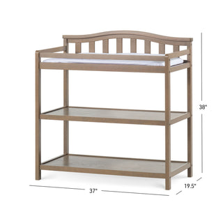 The Child Craft Arch Top Baby Changing Table in Dusty Heather features a curved slatted back, two open shelves, and a white changing pad. Perfect for the nursery, it measures 38"H x 37"W x 19.5"D.