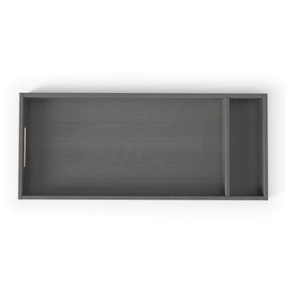 The F01792 Universal Changing Table Topper by Child Craft is a rectangular, midnight gray tray with two compartments—one large, one small—and a left-side cutout handle, designed to fit on top of a dresser.