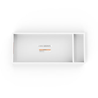 The Child Craft F01792 Universal Changing Table Topper in matte white features a rectangular design with two compartments—one large, one narrow—and visible warning labels. Shown from above on a white background.