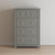 The Child Craft Atwood 4-Drawer Chest in Lunar Gray features white hexagonal knobs, a patterned top drawer, and three plain drawers. Shown on a light wood floor against an off-white wall.