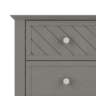 Close-up of the Child Craft Atwood 3-Drawer Dresser in Lunar Gray, showing two drawers: the top with a diagonal slat pattern and the bottom plain. Both feature hexagonal white knobs.