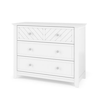 The Child Craft Atwood 3-Drawer Dresser in Matte White features a chevron-patterned top drawer with two knobs and two smooth-finish lower drawers, each with two knobs.