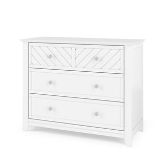 The Child Craft Atwood 3-Drawer Dresser in Matte White features a chevron-patterned top drawer with two knobs and two smooth-finish lower drawers, each with two knobs.