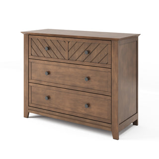 The Child Craft Atwood 3-Drawer Dresser in Cocoa Bean features a modern chevron pattern on the top drawer, round knobs, and a warm brown finish for a clean, contemporary look.