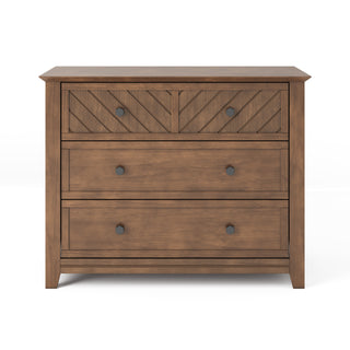 The Child Craft Atwood 3-Drawer Dresser in Cocoa Bean features a natural wood finish, a geometric herringbone pattern on the top drawer, two plain lower drawers, and round dark knobs for each drawer.