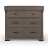 The Child Craft Redmond 3 Drawer Dresser in Dapper Gray features two small top drawers with round black knobs, a large lower drawer with a black handle, and raised edges on the top to help keep items secure.