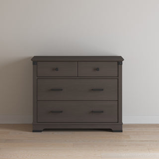 A Child Craft Redmond 3 Drawer Dresser in Dapper Gray features three spacious drawers, sleek handles, and a modern design—ideal for use as a nursery dresser.