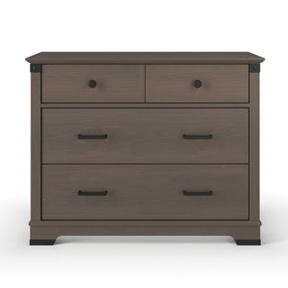 The Child Craft Redmond 3 Drawer Dresser in Dapper Gray features two small top drawers with round black knobs and a large lower drawer with rectangular handles.