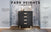 The Park Heights 4-Drawer Chest - Caviar Black by Child Craft features sleek Amish craftsmanship, roomy drawers, light wood handles, Brazilian hardwood feet, and is delivered fully assembled—perfect against any patterned wall.