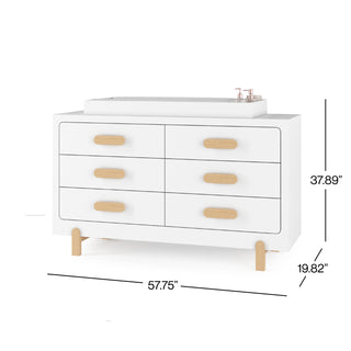 The Child Craft Legacy Changing Table Topper in matte white sits atop a six-drawer double dresser with light wood handles and legs. Dimensions: 57.75"W x 37.89"H x 19.82"D.