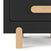 A close-up of the Child Craft Park Heights Night Stand - Caviar Black, a modern nightstand featuring a black cabinet, light Brazilian hardwood legs, and an oval wooden drawer handle.