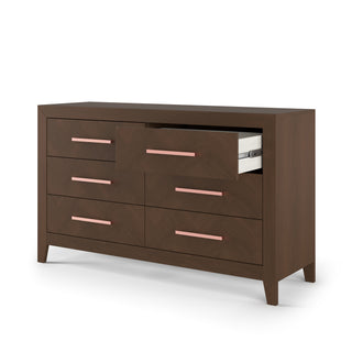 The Child Craft Kieran 6-Drawer Double Dresser in Toasted Chestnut features pink handles, angled legs, and a dark brown finish. The top middle drawer is partly open, showing the light-colored interior.