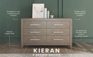 The Child Craft Kieran 6-Drawer Double Dresser in Crescent Gray stands against a green wall, featuring modern design, angled feet, herringbone pattern, brushed nickel handles, decor on top, and white design highlights.