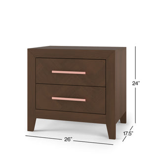 The Child Craft Kieran Nightstand in Toasted Chestnut features two drawers with rose gold handles, angled legs, and compact dimensions (24"H x 26"W x 17.5"D)—ideal for bedrooms or nurseries.