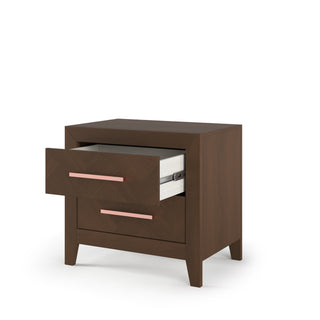 The Child Craft Kieran Nightstand in Toasted Chestnut features two drawers (one partially open with a folder), baby-safe finishes, and pink handles—ideal for safe, stylish nursery storage.