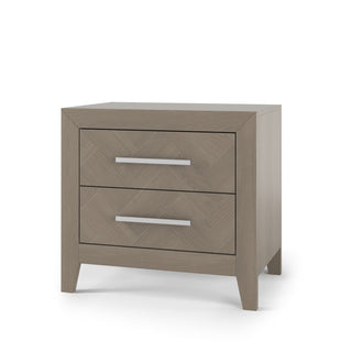 The Child Craft Kieran Nightstand in Crescent Gray features two drawers with sleek horizontal silver handles, a simple modern design, angled legs, and a smooth finish.