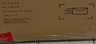 A brown cardboard box with shipping details and mail icon, sealed with clear and red tape, safely delivers the Child Craft Cranbrook 4-in-1 Convertible Crib in Toasted Chestnut—ideal for nursery furniture shipments.