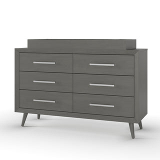 The Child Craft Cranbrook Double Dresser in Lunar Gray features six drawers with silver handles, a raised back panel, and four angled legs for a sleek mid-century modern look, shown here against a plain white background.