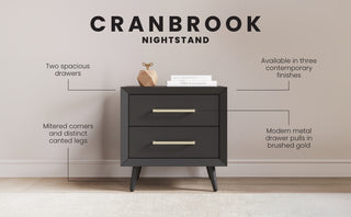 The Child Craft Cranbrook Nightstand in Ebony features two spacious drawers, brass gold handles, angled legs, and mitered corners, blending mid-century modern style with nursery furniture versatility.