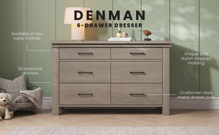 The Child Craft Denman Double Dresser in Crescent Gray stands against a green wall, topped with decor and a lamp. Rustic finishes, spacious six drawers, stepped molding, and craftsman-style metal pulls are featured. A teddy bear and ball sit on the floor.
