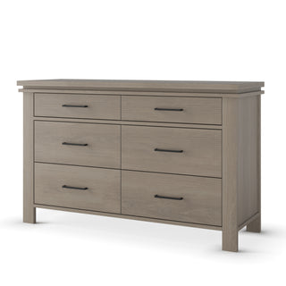 The Child Craft Denman Double Dresser in Crescent Gray features six drawers with black metal handles, a flat top, sturdy legs, and a simple modern design.