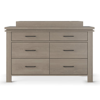 The Child Craft Denman Double Dresser in Crescent Gray features six drawers, black handles, a rectangular shape, and a simple modern design, shown against a white background.