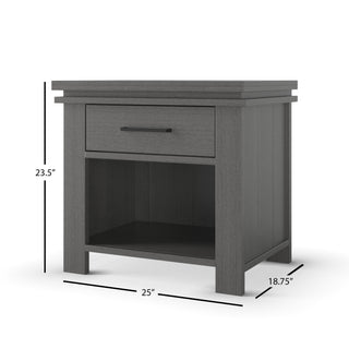 The Child Craft Denman Nightstand in Midnight Gray features one drawer with a horizontal handle, an open bottom shelf, and measures 23.5" tall, 25" wide, and 18.75" deep.