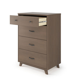 The Child Craft Soho 4 Drawer Chest in Dusty Heather features angled legs, black handles, and a light wood interior—an ideal mid-century modern piece for stylish nursery storage.